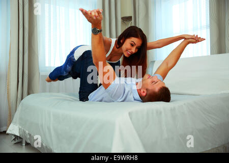 Happy couple having fun at home. Flying concept. Stock Photo