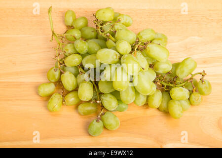 A bunch of green seedless grapes on a wood table Stock Photo