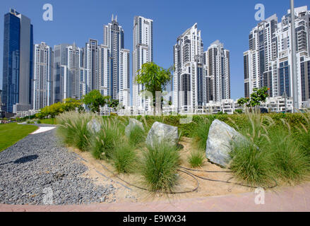 Modern landscaping in park adjacent apartment towers at Bay Avenue development in Business Bay Dubai United Arab Emirates Stock Photo
