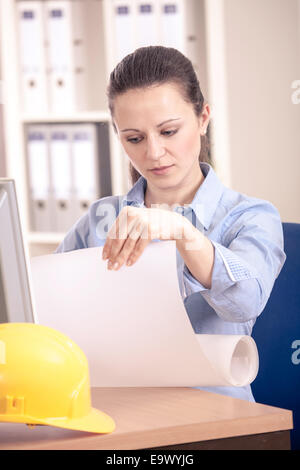A young female architect working in the office Stock Photo
