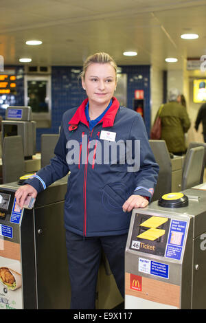 London, UK. 3rd November, 2014. Tube staff get new uniforms, Oxford Circus, London, UK 03.11.2014 Today Transport For London Tube staff wearing new uniforms designed by Wayne Hemingway. The Tube logo now appears on pockeys and cuffs and is also embroidered on the back of uniforms. The tube workers trying out the new uniforms were joined by the designer during their shift at Oxford Circus tube station. (pictured) Sarah Beighton (Customer Service Provider) modelling the new uniform. Credit:  Clickpics/Alamy Live News Stock Photo