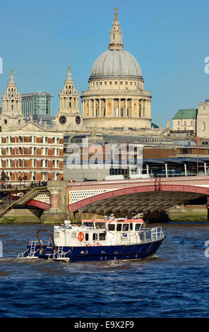 London, England, UK. Port of London Survey boat passing under Blackfriars Bridge, St Paul's Cathedral behind Stock Photo
