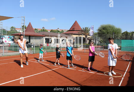 Female tennis coach teaching a group of children in Belek,Antalya,Turkey Stock Photo