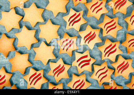 Christmas cookies in star shape on a blue background with red stripes Stock Photo