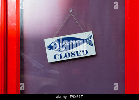 Closed sign on door of fish & chip shop Stock Photo