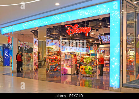 Shoppers in Disney retail store entertainment business open plan full width entry from indoor Intu Lakeside shopping mall Thurrock Essex England UK Stock Photo