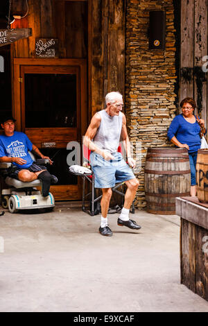 Senior male dancing to the music being played by an Appalachian folk band in Gatlinburg TN Stock Photo