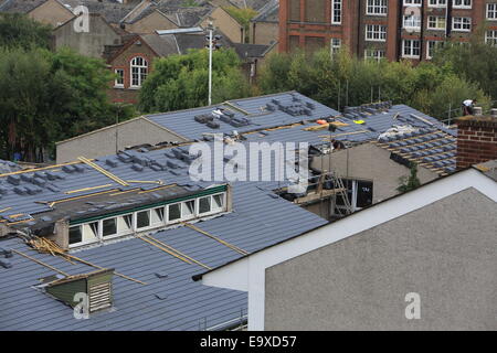 Putting new slate tiles on roof in north London, England, UK Stock Photo