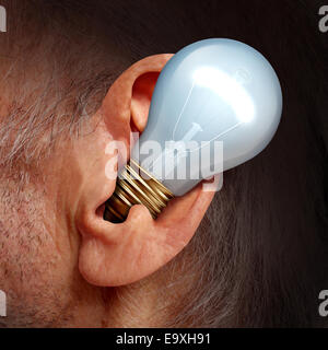 Listen to ideas concept as a lightbulb inside a human ear as a symbol of listening and tuning in to creative thoughts and hearing success advice. Stock Photo
