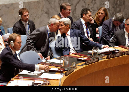 United State's Secretary of State John Kerry talks to an aide as he chairs a meeting of the Security Council at UN Headquarters