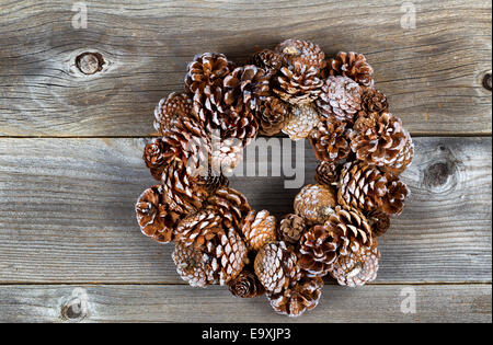 Real pine cone wreath for the Christmas season on rustic wooden boards Stock Photo