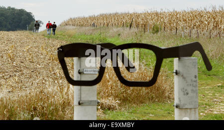 Clear Lake, IOWA, USA. 5th Oct, 2014. At the intersection of Gull Avenue and 315th Street North of Clear Lake, Iowa is giant pair of glasses making the nearest roadside location to the Buddy Holly plane crash site. Following the fence about a 1/2 mile down a dirt path into a cornfield to the memorial where the plane carrying Buddy Holly, Ritchie Valens and J.P. ''The Big Bopper'' Richardson crashed killing all aboard on Feb. 3, 1959. The three young singers were in a single-engine aircraft flying in a light snowstorm in 1959 when the pilot apparently lost control. Holly decided to fly because Stock Photo