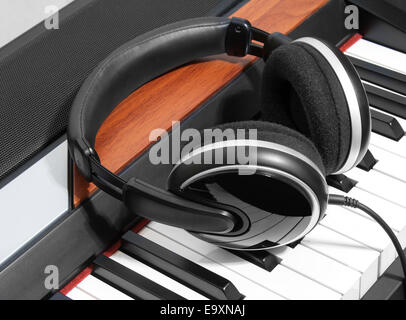 Headphones are on the piano keys closeup Stock Photo