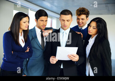 Business people reading a document together Stock Photo