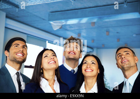 Happy positive business group looking up with dreaming expression Stock Photo