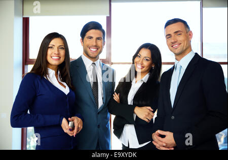 Group of cheerful business people standing in office Stock Photo