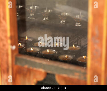 Oil lamps burning in Tango Monastery, Thimphu, Bhutan Stock Photo