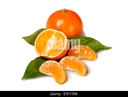 Whole and a half Mandarine, individual pieces on leaves Stock Photo