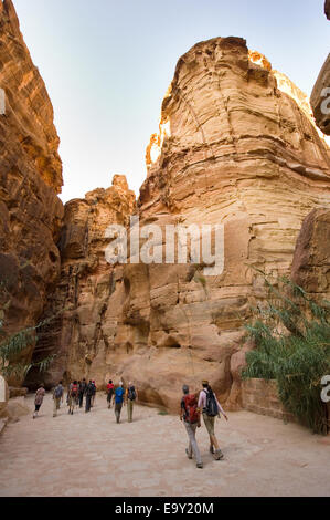 Tourists are walking through 'the Siq'.'The Siq' is a narrow gorge who leads visitors into Petra in Jordan