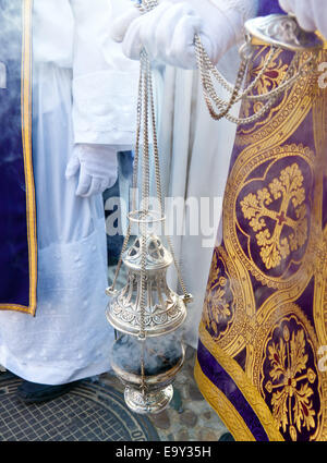 A jar full of incense in a religious procession. Stock Photo