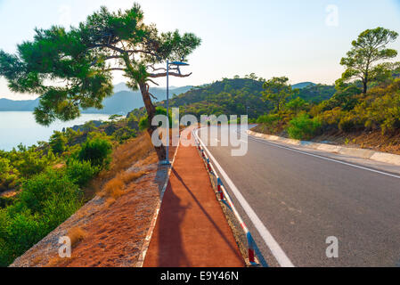 good asphalt road in the mountains near the sea Stock Photo