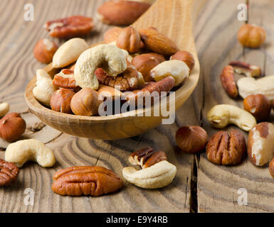 Mix nuts on a wooden table. Selective focus Stock Photo