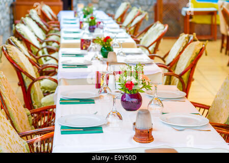 long beautifully set table in a restaurant Stock Photo