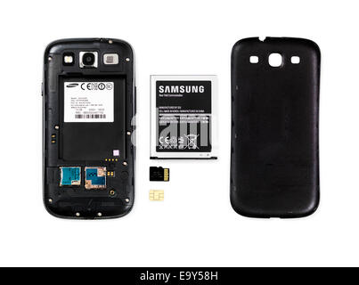 Samsung Android phone with the rear cover removed and battery, memory and SIM card taken out isolated on white background Stock Photo