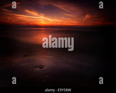 Dramatic dark red sunset over lake Huron, Pinery Provincial Park, Grand Bend, Ontario, Canada. Stock Photo