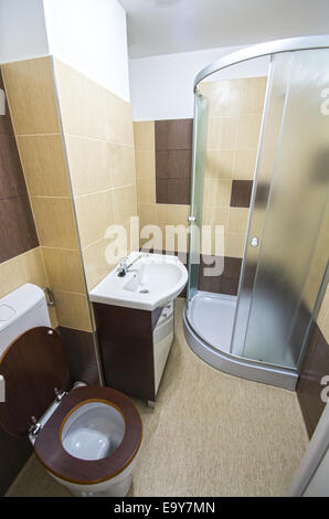 Small hotel bathroom with shower cabin. Stock Photo