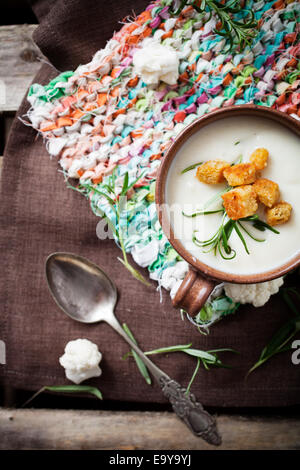 Creamy cauliflower soup with herbs and crutons Stock Photo