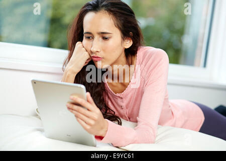 Girl browsing websites using iPad Stock Photo