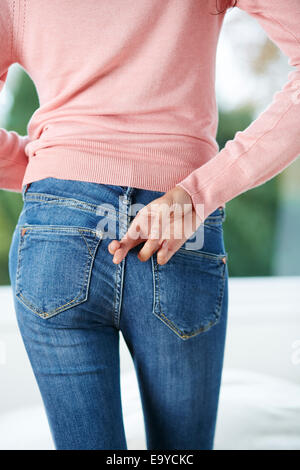 Woman with fingers crossed behind her back