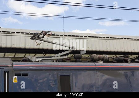 Power collection pantograph and overhead power lines on the electrified East Coast Main Line railway at Newcastle train station.