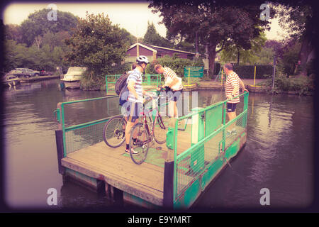 Passengers using the hand wound chain ferry to cross to Trowlock Island on the Thames instagram effect Stock Photo