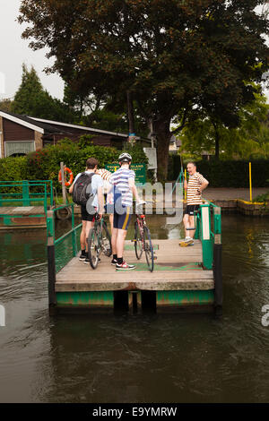 Passengers using the hand wound chain ferry to cross to Trowlock Island on the Thames Stock Photo