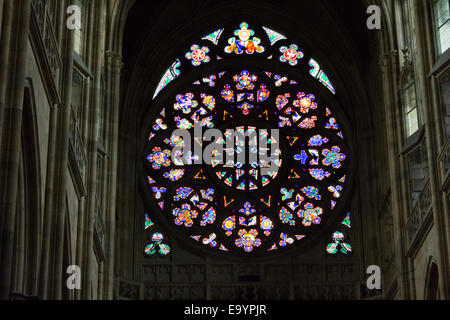 Decal window transparency of rosette  inside the cathedral of St Vitus in Prague, a church with dark Gothic towers guarded by ga Stock Photo