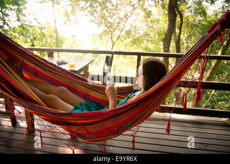 A woman relaxing in a hammock. Montezuma, Costa Rica Stock Photo