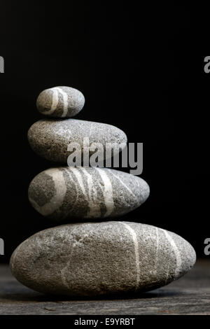 Stacked stones on a black background Stock Photo