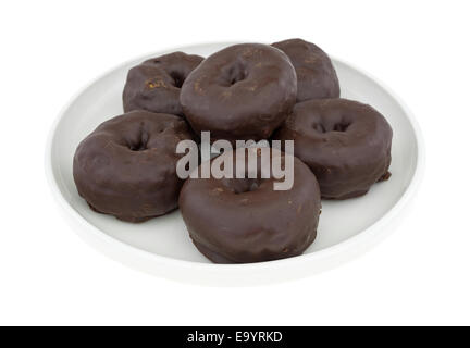 A group of small chocolate iced donuts on a plate atop a white background. Stock Photo
