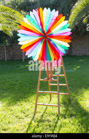 Girl putting up decoration in garden Stock Photo