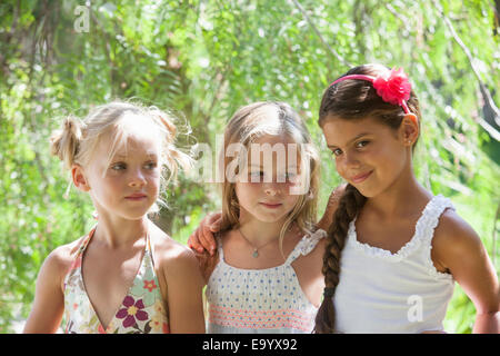 Candid portrait of three girls in garden Stock Photo