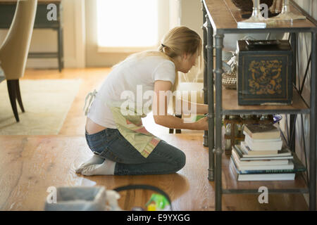 Young woman cleaning home with green cleaning products Stock Photo