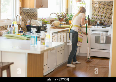 Young woman mopping with green cleaning products Stock Photo