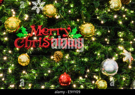 Merry Christmas sign on the tree that is decorated beautifully Stock Photo