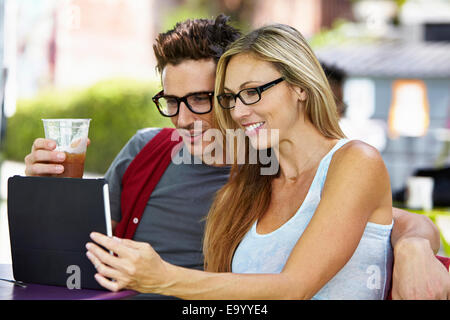 Couple using digital tablet at cafe Stock Photo