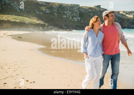 Mature couple strolling on beach, Camaret-sur-mer, Brittany, France Stock Photo