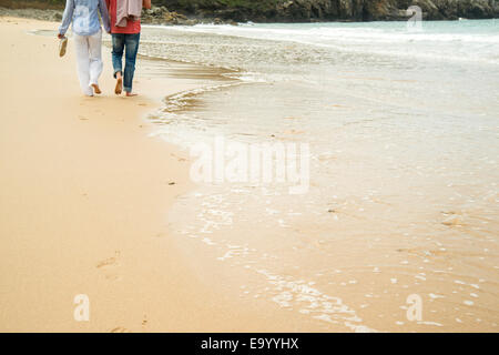 Cropped shot of mature couple strolling on beach, Camaret-sur-mer, Brittany, France Stock Photo