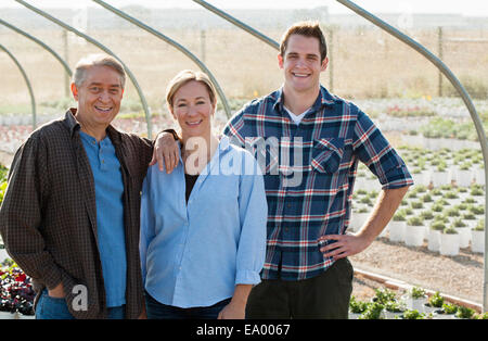 Portrait of three workers in plant nursery polytunnel Stock Photo