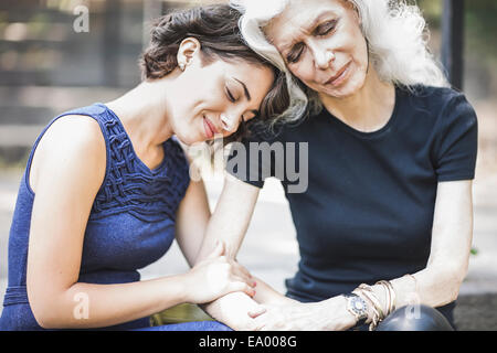 Young woman sharing tender moment with mentor